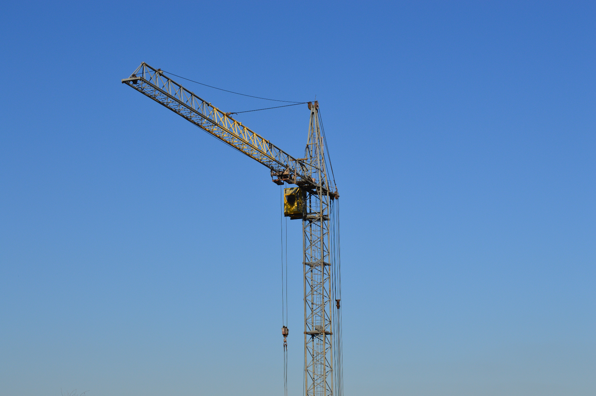 Construction tower crane against blue sky